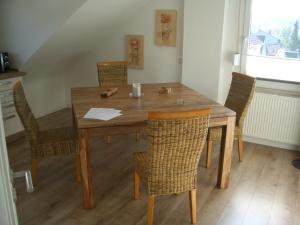 a dining room table with chairs and a wooden table at No Beach in Solingen