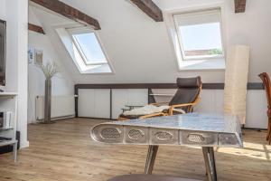 salon ze stołem i 2 oknami w obiekcie fewo1846 - Hugo Eckener - komfortable Maisonette-Wohnung mit 2 Schlafzimmern im Stadtzentrum w mieście Flensburg