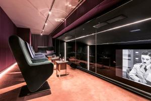 a living room with a couch and a tv at mk2 Hotel Paradiso Nation in Paris