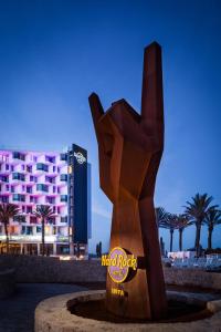 a statue in front of a hotel with a building at Hard Rock Hotel Ibiza in Playa d'en Bossa
