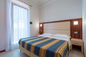 Ένα ή περισσότερα κρεβάτια σε δωμάτιο στο Delle Rose