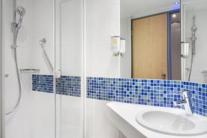 a bathroom with a glass shower and a sink at Holiday Inn Express Baden-Baden, an IHG Hotel in Baden-Baden