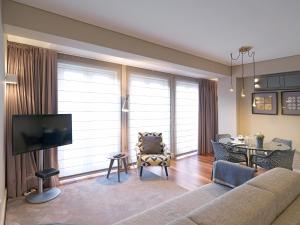 a living room with a couch and a dining room at FLH New Oporto Apartments - São Bento in Porto