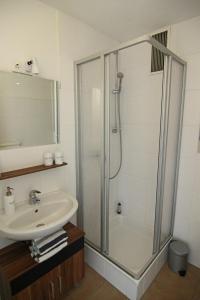 a bathroom with a shower and a sink at Nina in Wenningstedt