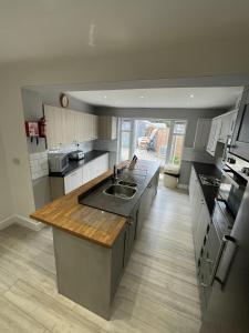 a large kitchen with a sink and a counter at Cranmore Guest House in Solihull