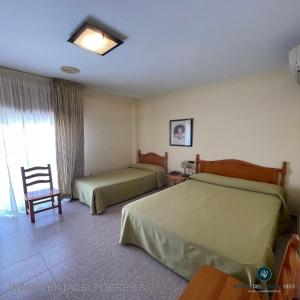 Säng eller sängar i ett rum på Hotel Venta del Pobre