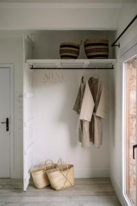 a walk in closet with baskets on a wall at BYPILLOW Cap Sa Sal in Begur