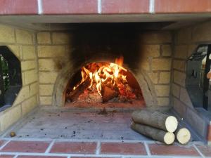 a brick oven with a fire in it at Apartment Bankya in Bankya