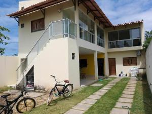 a house with two bikes parked in front of it at Propriedade patolo in São Miguel dos Milagres