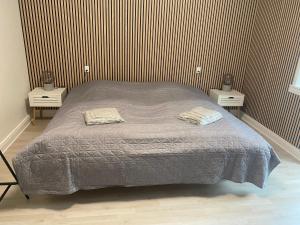 a bedroom with a bed with two nightstands and two tables at Just Sleep Delux in Brande +18 photos