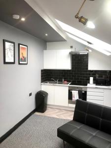 a living room with a couch and a kitchen at CLIFTON Apartments in Liverpool +59 photos