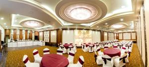 a banquet hall with red and white tables and chairs at Hotel Annapoorna Residency in Hyderabad