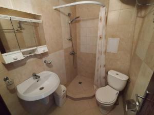 a bathroom with a sink and a toilet and a shower at Sunny Sands Studios in Burgas