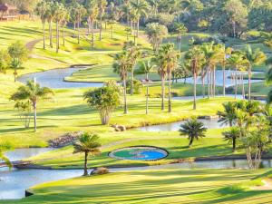 an aerial view of a golf course with palm trees and water at San Lameer Villa 1928 by Top Destinations Rentals in Southbroom