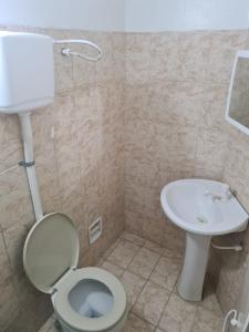 a bathroom with a toilet and a sink at BeB Hotel in Macapá