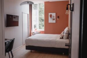 Un pat sau paturi într-o cameră la Hôtel-Restaurant Villa Métis