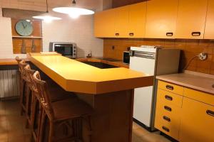 a kitchen with a yellow counter top and a refrigerator at CA LA ROSITA in Solsona
