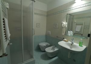 a bathroom with a sink and a toilet and a shower at Caprice in Avigliana +55 photos