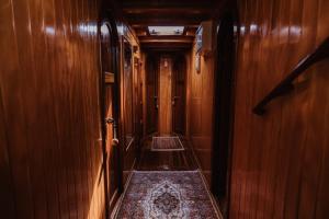 a corridor of a train with wooden walls and a rug at Sicily Sea Charter HANDE CAPO GALERA in Palermo