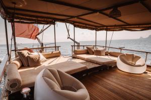 a boat with couches and chairs on the water at Sicily Sea Charter HANDE CAPO GALERA in Palermo