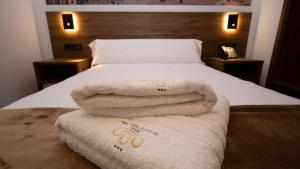 A bed or beds in a room at Encanto Tarazona