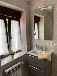 a bathroom with a sink and a mirror at Las tres Luces Casa 2 in Picones