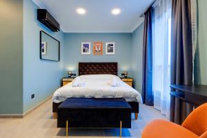 Un dormitorio con una cama con una pared azul. en Art Deco Luxury Apartment, Central Location, en Sliema 45 fotos más