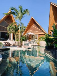 an infinity pool in a villa with a resort at Beyond Bayou in Seminyak