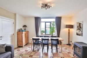 a living room with a table and chairs at La Cense de Baudecet - Le Corps de Logis in Gembloux