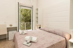 Postel nebo postele na pokoji v ubytování Hotel Ninfea Cattolica