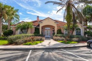 ein Haus mit Palmen vor einer Straße in der Unterkunft Magical Fiesta Key Townhouse in Kissimmee
