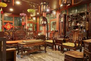 a room with a bunch of chairs and a clock at Beijing Rong Courtyard Boutique Hotel in Beijing