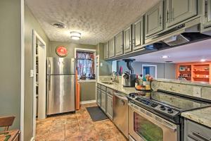 a kitchen with gray cabinets and a stainless steel refrigerator at Mercersburg Cottage, 7 Mi to Whitetail Resort in Mercersburg