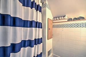a bathroom with a blue and white shower curtain at Mercersburg Cottage, 7 Mi to Whitetail Resort in Mercersburg +23 photos