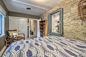 a bedroom with a bed and a stone wall at Mercersburg Cottage, 7 Mi to Whitetail Resort in Mercersburg