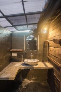 a bathroom with a sink and a mirror at Tropical Canggu Hostel in Canggu