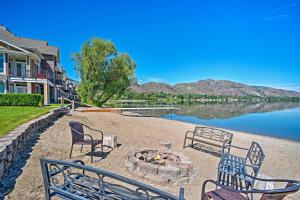 a group of chairs sitting around a fire pit next to a lake at Lakefront Resort Townhome with Gas Grill and Kayaks! in Oroville