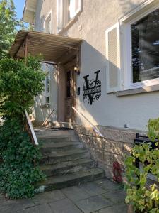 a house with stairs leading up to the front door at Boutique Apartment Villa Landenberger Outlet Metzingen P12E in Metzingen