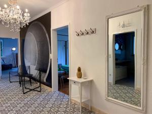 a living room with a mirror and a room with a table at Boutique Apartment Villa Landenberger Outlet Metzingen P12E in Metzingen +27 photos