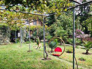 a playground with two swings in a yard at Winehouse in Lagodekhi