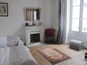 a living room with a couch and a fireplace at ChezLola in Civray