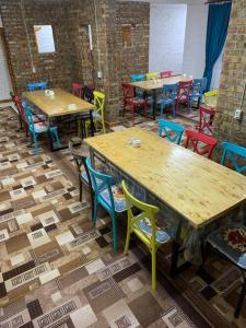 a room with tables and colorful chairs and tables at Kolsay Aisha in Saty