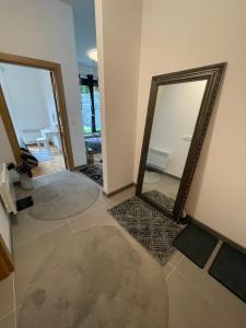 a living room with two mirrors on the floor at Bjelasnica White apartmani in Bjelašnica