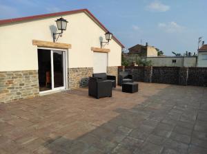 eine Terrasse mit 2 Stühlen und ein Gebäude in der Unterkunft Casa Rural Maño in Deltebre