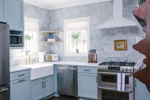 a kitchen with white counters and a stove top oven at Guesthouse Charleston EAST 42 B in Charleston