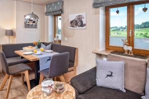 a living room with a table and chairs and a dining room at Haus Gorbach in Oberstaufen