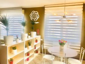 a dining room with a table and some potted plants at ATTICO IN FIERA apartment in Bologna