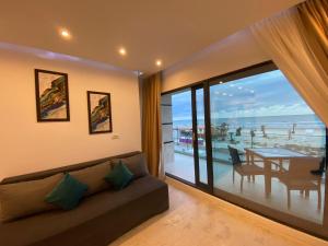 a living room with a couch and a view of the ocean at Apartament Ella front view in Mamaia Sat/Năvodari