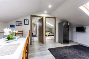 a kitchen and a living room with a refrigerator at Casa Andy in Buşteni