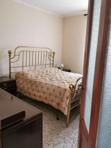 a bedroom with a bed and a dresser and a table at Da Zio Guido! in Bussoleno
